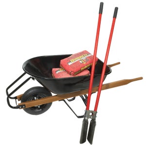 Wheelbarrow loaded with bags of fast setting concrete mix and hand tools