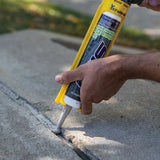Sealant applied from the tube into a crack in a concrete slab