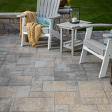 Finished grey paver patio with tight sand joints, Adirondack chairs and side table – polymeric sand patio result