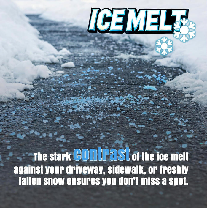 Blue ice melt granules scattered across a dark asphalt driveway with snow banks on the sides showing stark color contrast