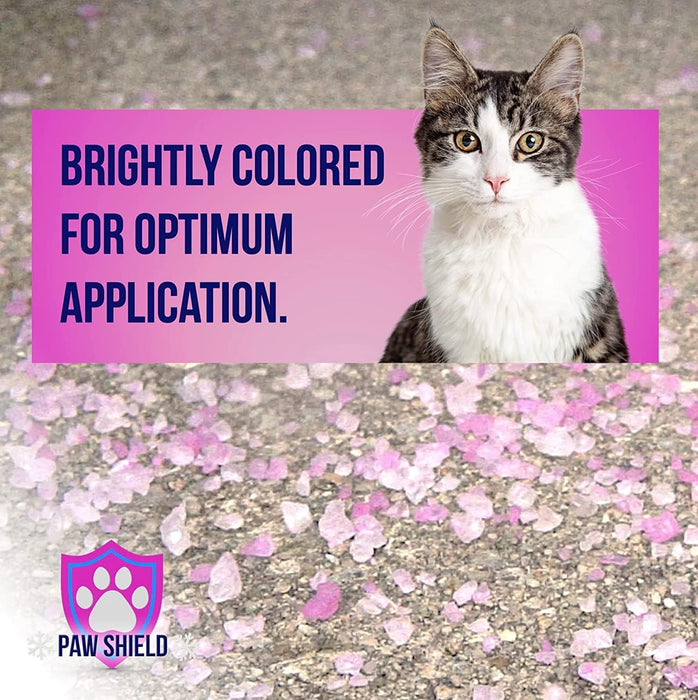 Paw Shield brightly colored pink crystal ice melt granules spread on pavement with tabby cat