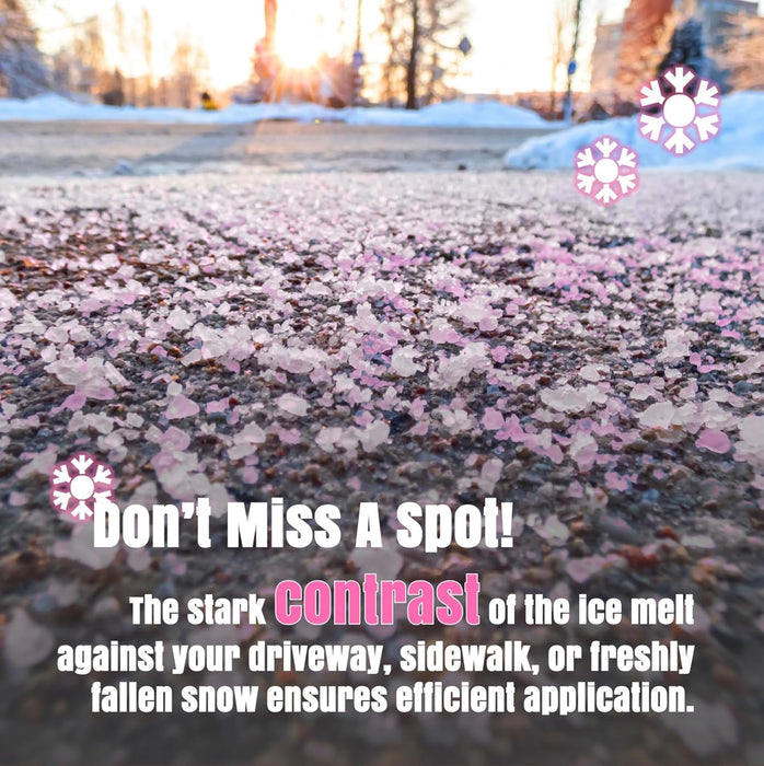 Pink-tinted ice melt granules spread across a dark asphalt surface with snow in the background