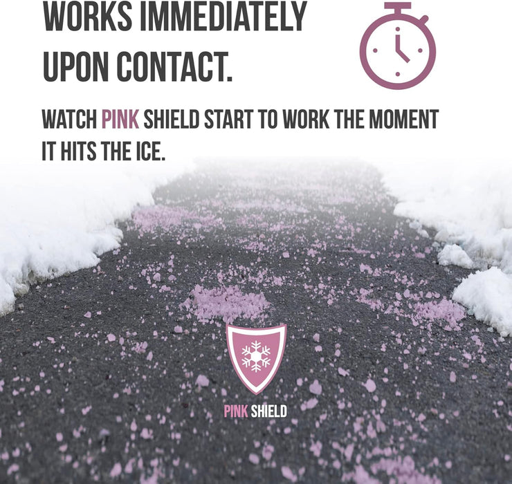 Pink Shield ice melt granules scattered on icy asphalt driveway with snow along edges