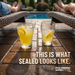 Polymeric Sand Store sealed brick paver patio beside a pool with two lemonade glasses and lounge chairs