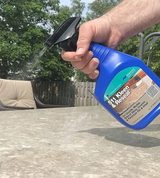 Spraying cleaner and sealer from the trigger bottle onto a hard surface