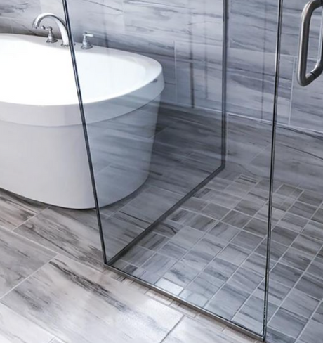 Tiled bathroom with a freestanding bath and a glass shower enclosure